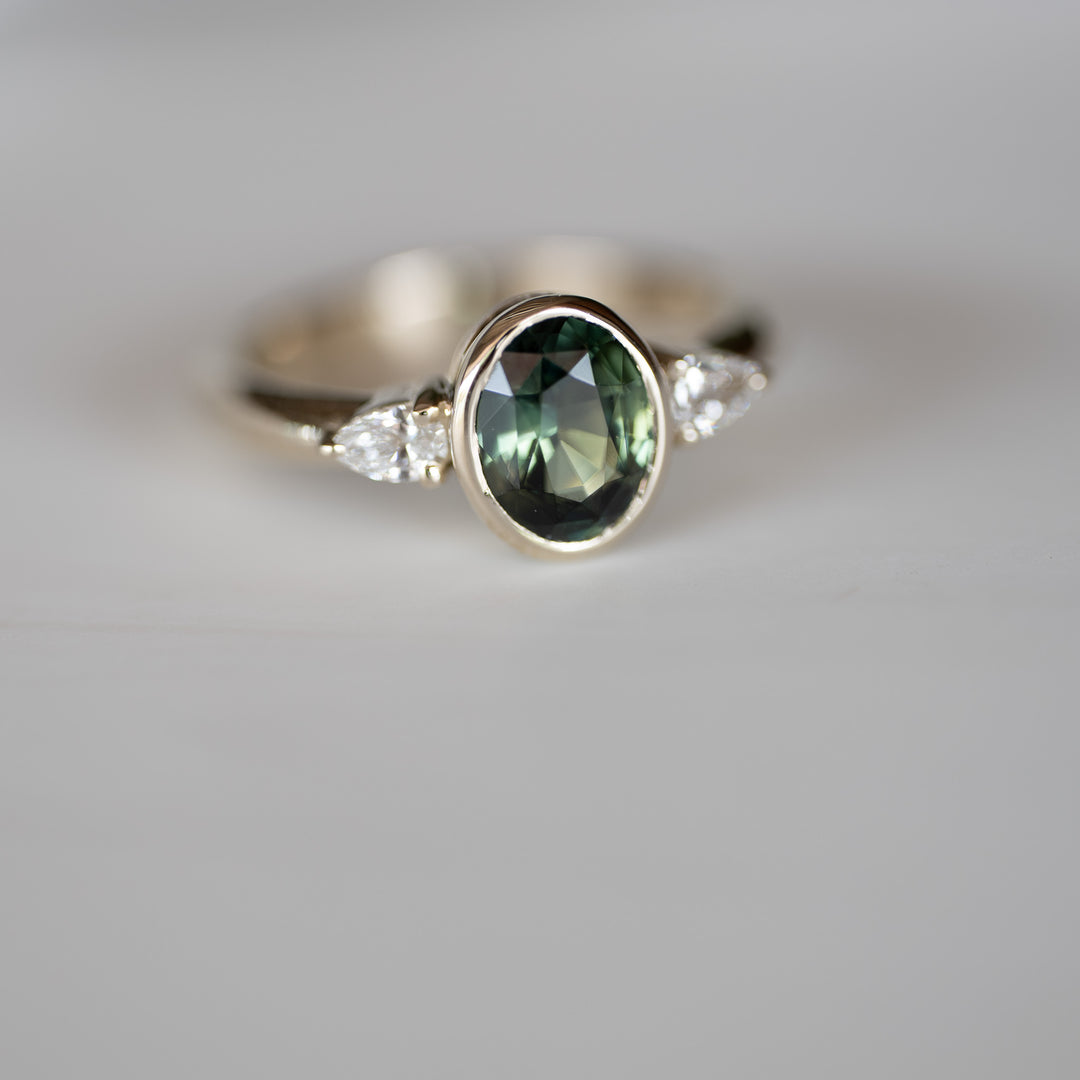 1.64 CT Oval Sapphire with Pear Side Stones
